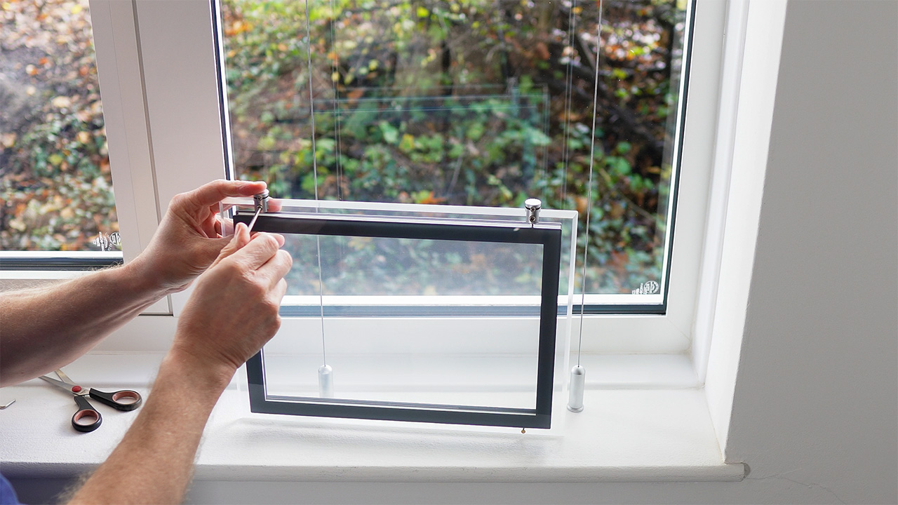 Using an Allen key to attach four panel clamps to a light pocket, one at each corner.