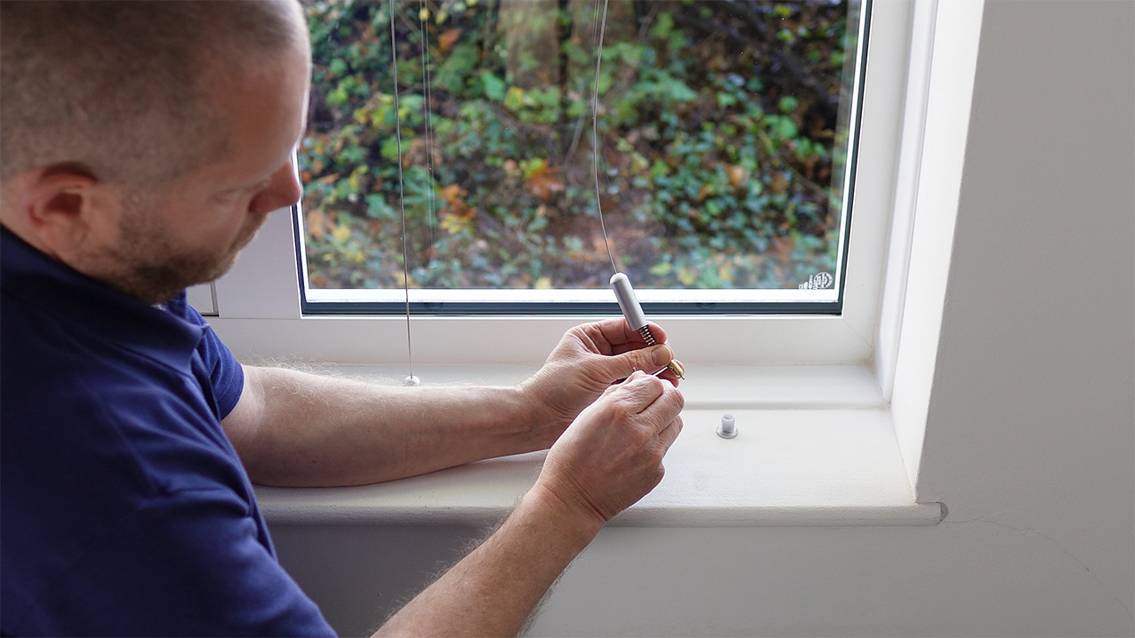 Using an Allen key to lock the adjustable sliding nipple in position approximately 5mm from the end of the cable.
