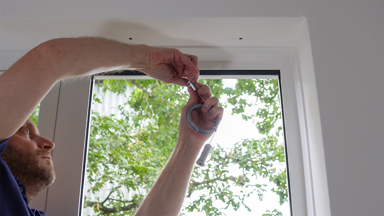 Unscrewing the cable kit's top inner fixing from its outer body.