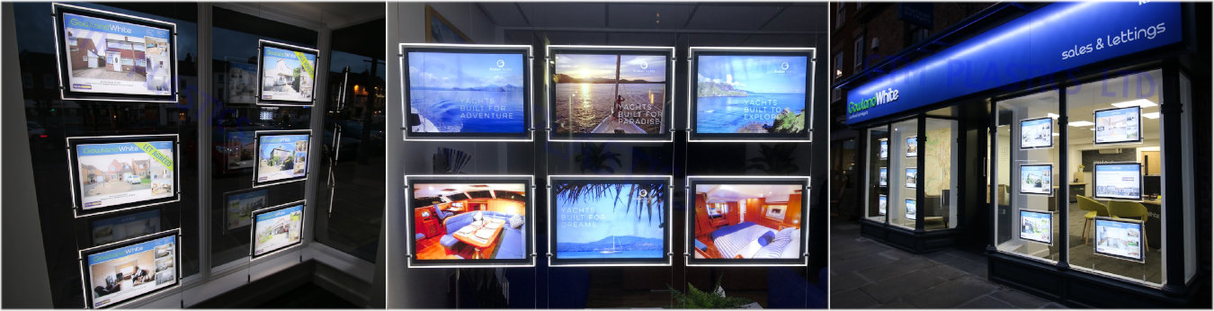Illuminated magnetically opening poster displays at night-time - hanging in various shop windows