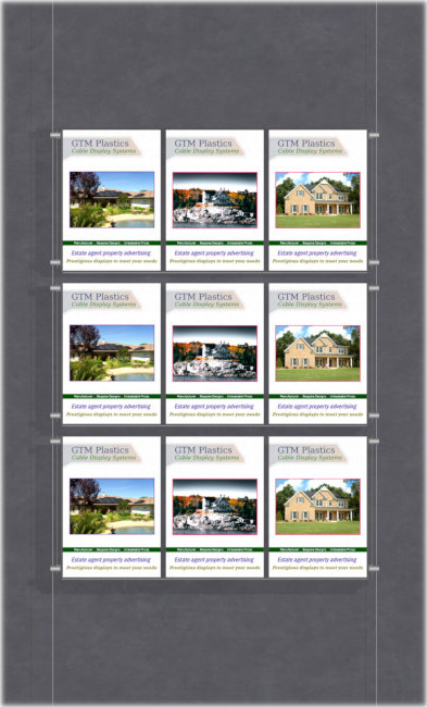 An acrylic poster holder display, cable suspended, consisting of three triple-width portrait acrylic poster sleeves, two floor to ceiling cables, and twelve mini clamps.