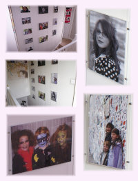 Wire suspended poster holders displaying family photos in home stairway