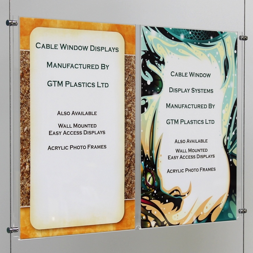 A closeup view looking from a slight angle, of one A4 double-width portrait acrylic poster pocket suspended between two cables.