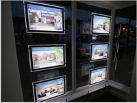 A3 LED pockets in a letting agent's window - looking right from inside the room