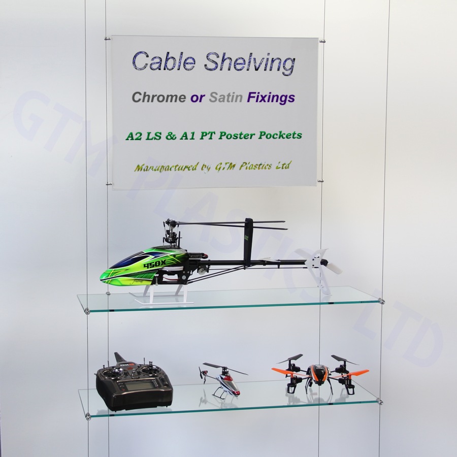 Glass wire suspended shelving displaying crockery with an optional poster holder between the cables